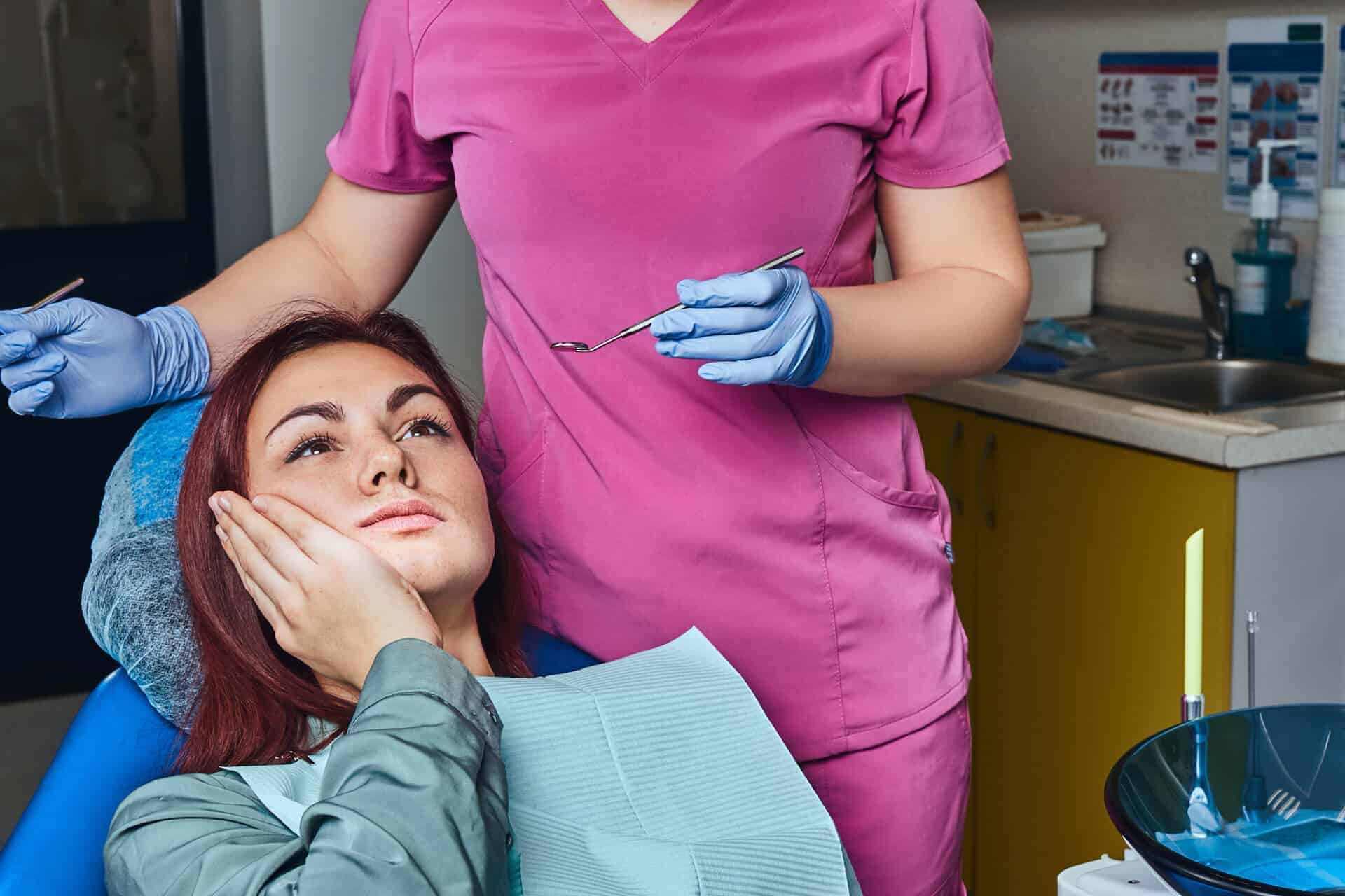 dentist treating tooth pain to a patient