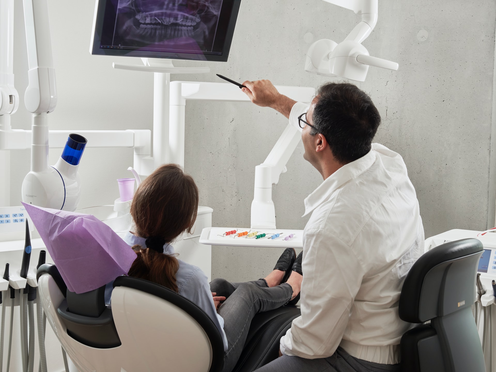 dentists looking at a dental xray for cosmetic surgery