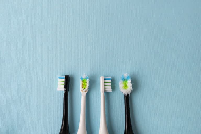 Modern electric toothbrush on a blue background