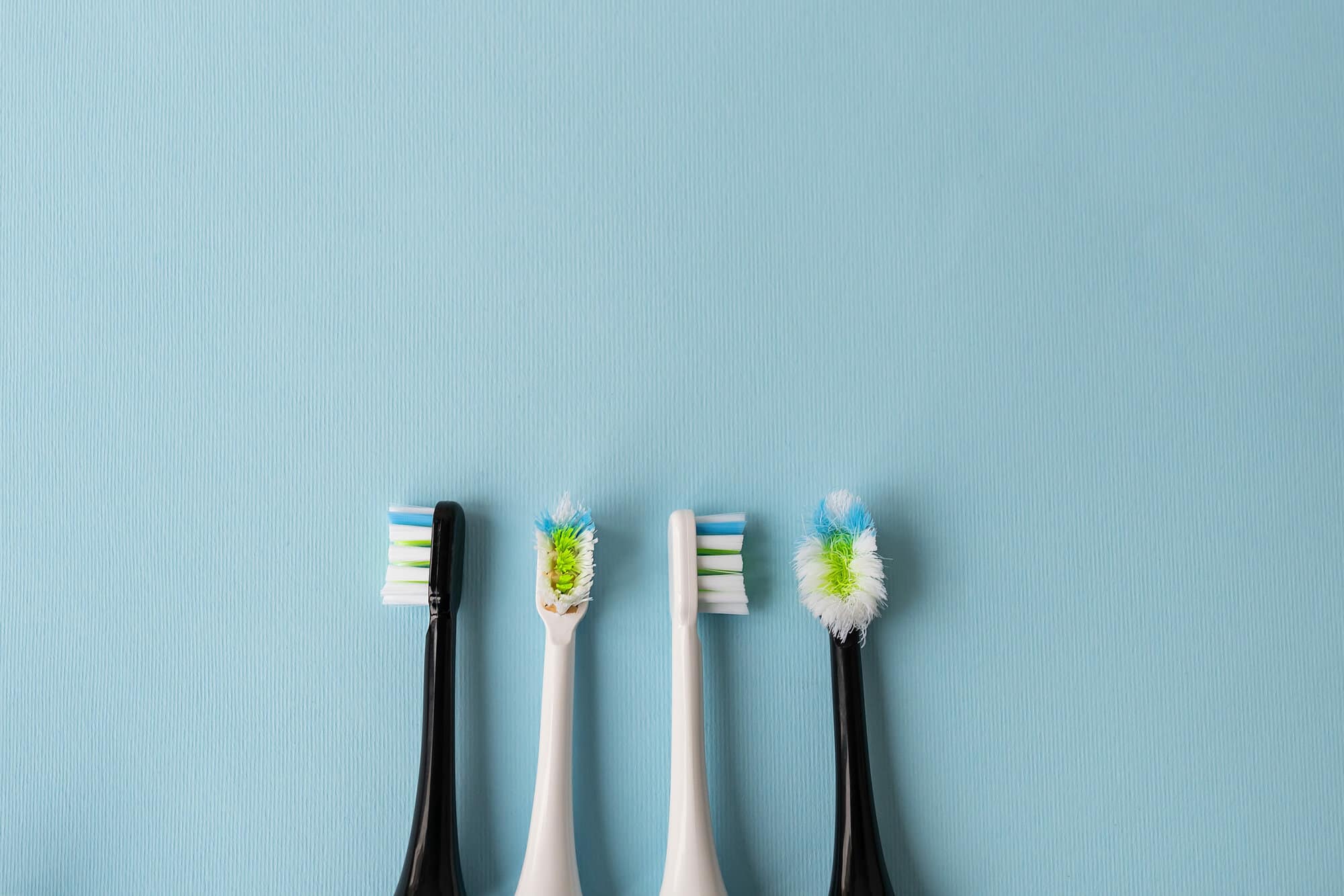 Modern electric toothbrush on a blue background