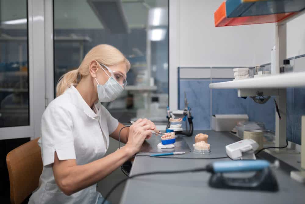 dental technician working on veneers to determine veneers cost