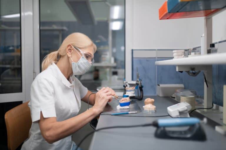 dental technician working on veneers to determine veneers cost